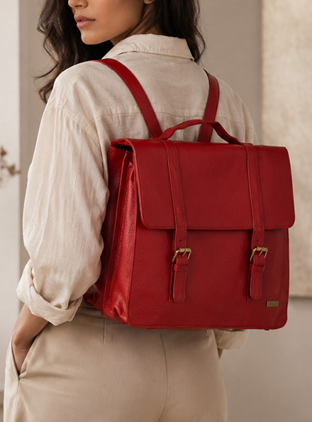 Red TANN IN leather work bag worn with an ivory outfit