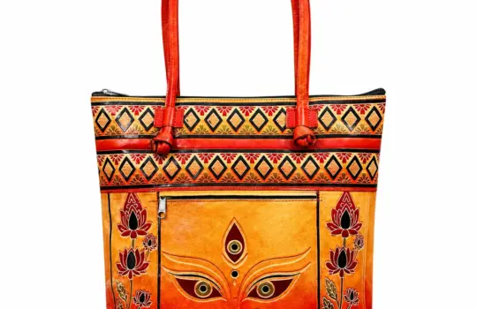 TANN IN Durga motif genuine leather tote bag for women in orange and red with lotus borders and shoulder handles